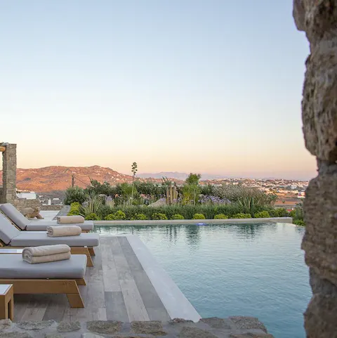 Slip into the serene swimming pool and admire the rugged landscape