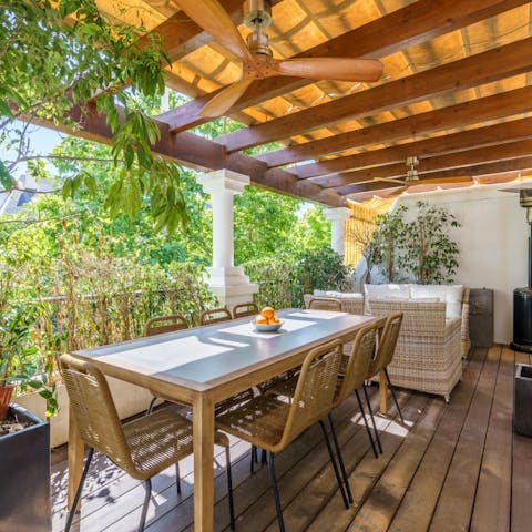 Tuck into some paella and tapas on the outdoor table