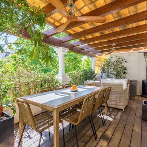 Tuck into some paella and tapas on the outdoor table