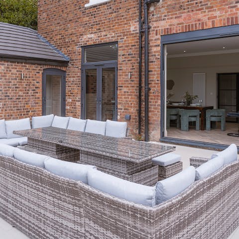 Grab the wine and gather around the large outdoor sofa