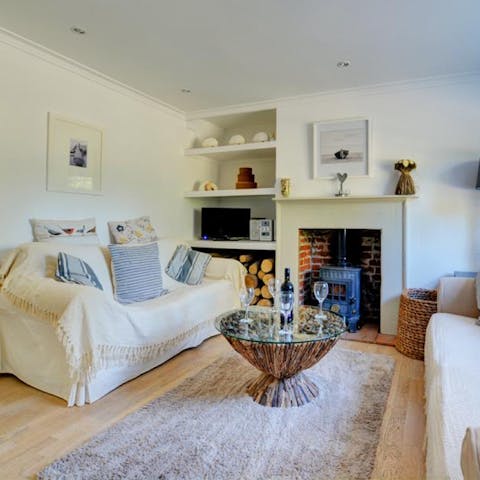 Light a fire in the living room stove to keep up the cosy vibes