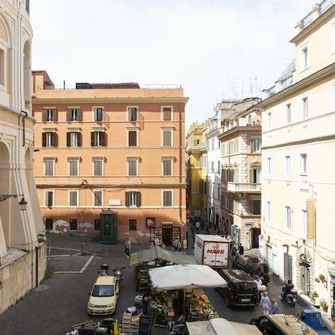 Admire the bustling Roman street scenes below your window