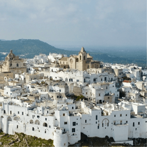 Trace the winding whitewashed lanes of nearby Ostuni