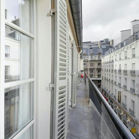 Watch the world go by on the street below from the balcony