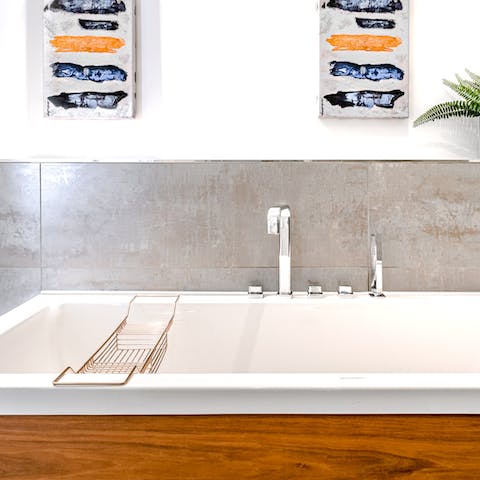 Treat yourself to a pampering session and a soak in the sleek modern bathroom