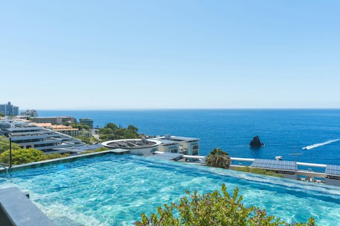Take a swim in the building's infinity pool with the Atlantic stretching before you