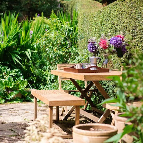 Begin your day with a cup of tea in the sunny cottage garden