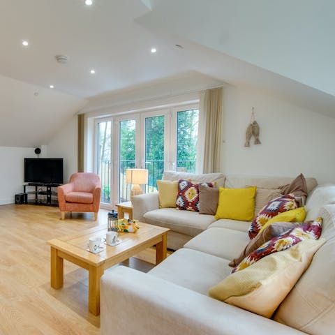 Curl up on the L-shaped sofa with a well-deserved glass of wine