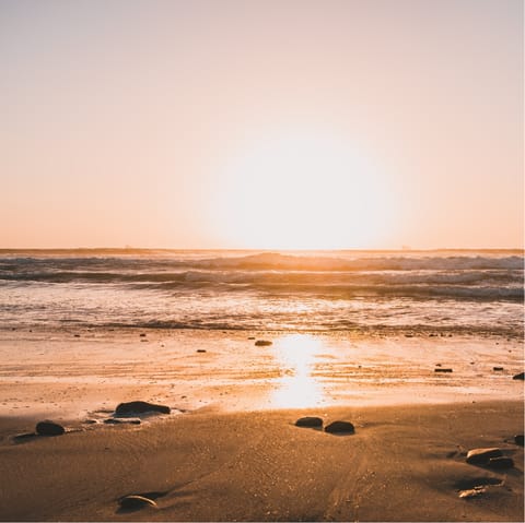 Stroll the shores of Robyn's Beach at the golden hour, it's a thirteen-minute walk away