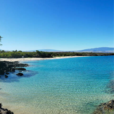Visit beaches like Hapuna, a fifteen-minute drive away