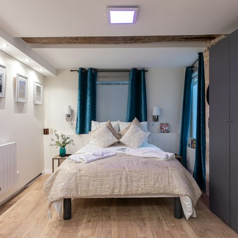Wake up refreshed and ready to go in the stylish modern bedroom with original features