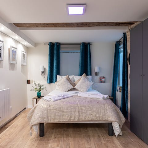 Wake up refreshed and ready to go in the stylish modern bedroom with original features