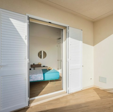 Open up the bedroom balcony doors and let the sea breeze in