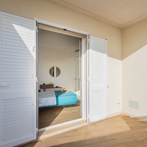 Open up the bedroom balcony doors and let the sea breeze in
