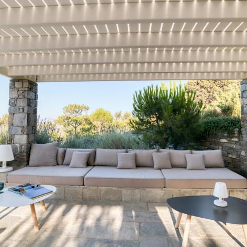 Find a shaded spot beneath wooden pergolas for a cold drink