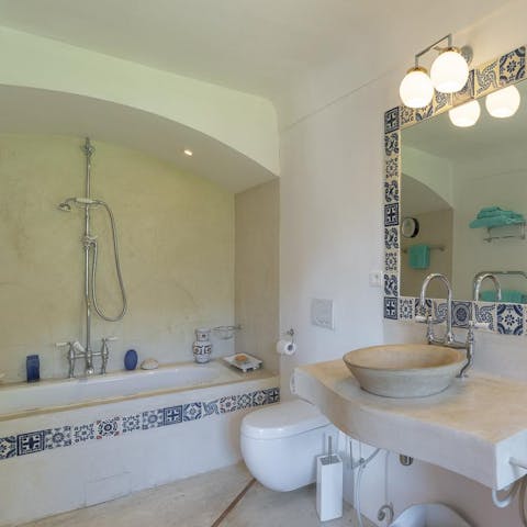 Treat yourself to a long soak in the prettily tiled bathtub