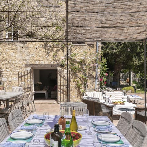 Serve up a Provençal feast to guests seated underneath the pergola