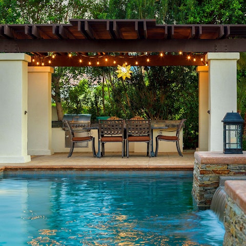 Paddle elegantly through the pool before taking a seat underneath the pergola