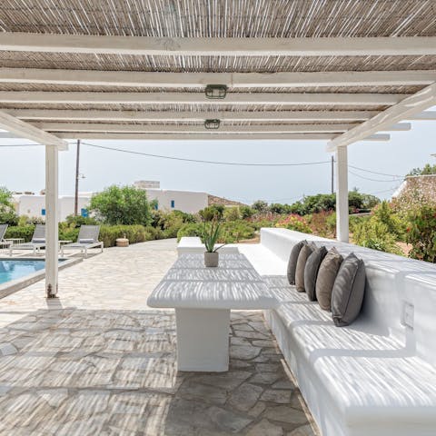 Relax under the shaded pergola with a cocktail in hand