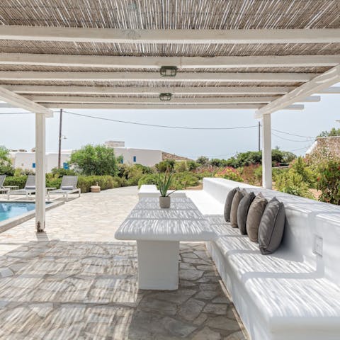 Relax under the shaded pergola with a cocktail in hand