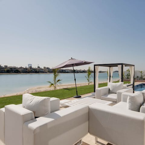Share drinks whilst looking out across the beach