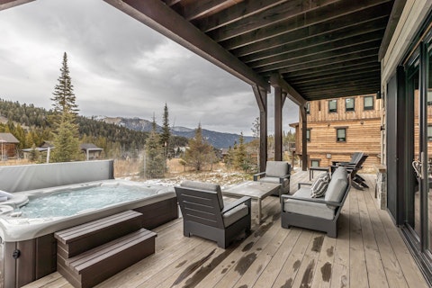 Soak in the hot tub with snow-dusted peaks all around