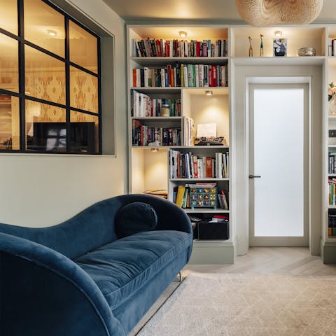 Choose a book and unwind on the plush chaise longue