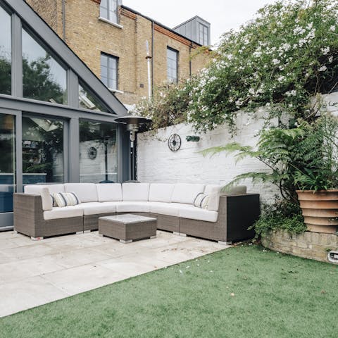 Relax on the sofa surrounded by flowering climbers
