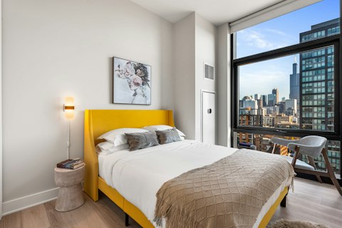 Wake up to Willis Tower framing your window above Chicago's rooftops