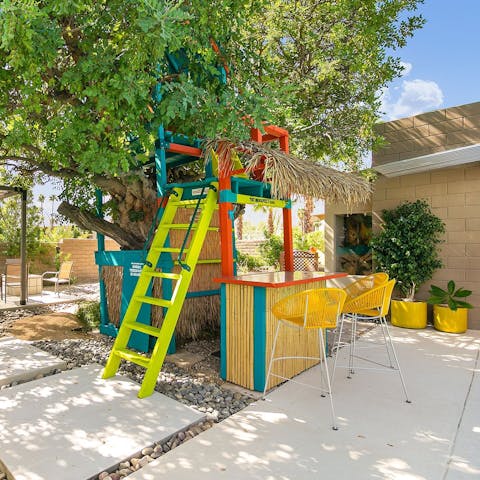 Whip up cocktails in the playful tree-house bar