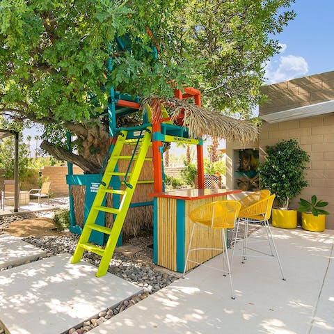 Whip up cocktails in the playful tree-house bar