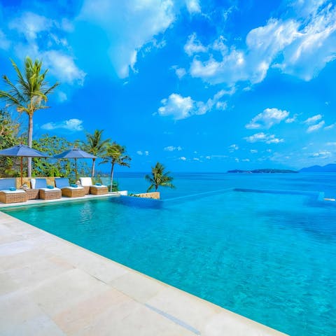 Sunbathe on comfy loungers and enjoy the  view from your private infinity pool