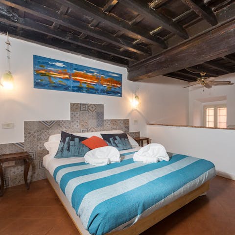Wake up in the beamed mezzanine bedroom feeling rested and ready for another day of Rome sightseeing