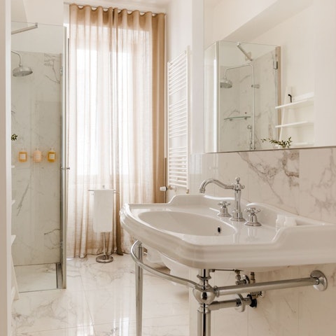 Wash the city off in the sleek marble bathroom
