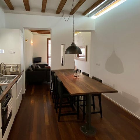 Gather around the chic dining table for dinners, drinks, and card games at home while the low-hanging light sets the mood