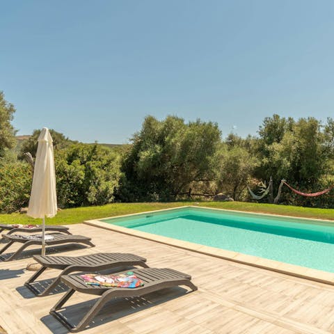Unwind by the pool in the Sardinian sunshine