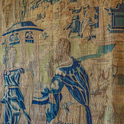 Admire the dining room's antique tapestry