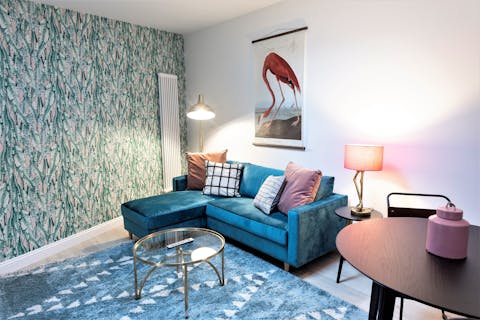 Relax on the large bespoke sofa and enjoy films on the 50-inch smart TV