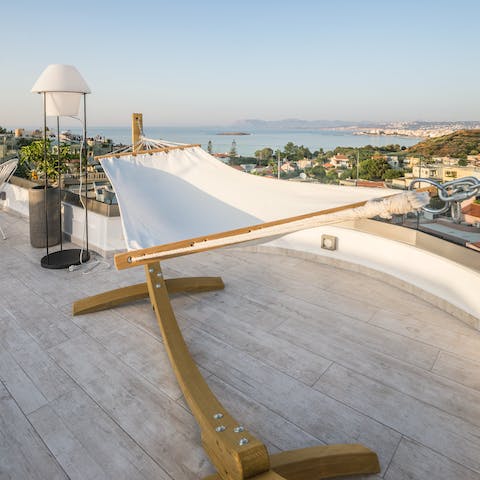 Swing lazily on the hammock as you drink in the stunning sea views