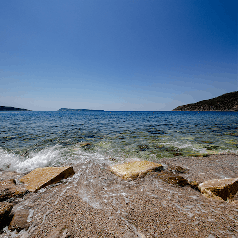 Splash around at the beach, less than a five-minute walk from home