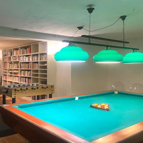 Play pool or have a glass of Italian wine, and choose a book from the library