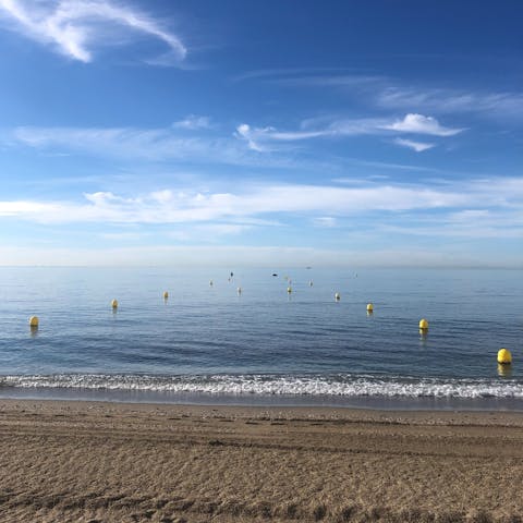 Spend the day on the sands of Playa de los Álamos, a short drive away