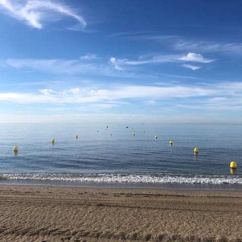 Spend the day on the sands of Playa de los Álamos, a short drive away