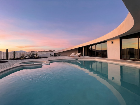Float in the pool as desert colours ignite the sky