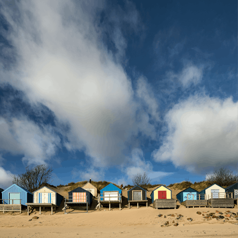 Check out the beautiful beaches of the Llyn Peninsula, with colourful beach huts and dreamy sand dunes