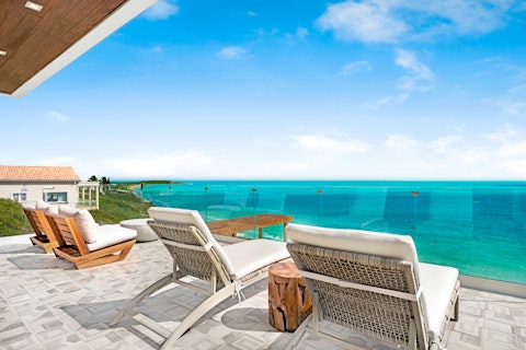 Stretch out on sun loungers above dazzling turquoise water