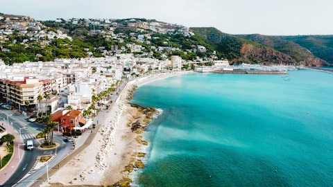 Swim and sunbathe on Jávea's beloved golden sandy bay, a ten-minute drive away