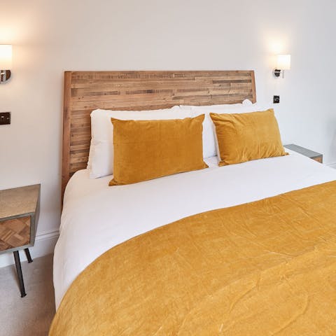 Get some rest in the comfy bed with its golden velvet throw