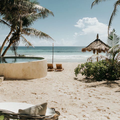 Spend the afternoon relaxing on the sandy beach on your sun loungers