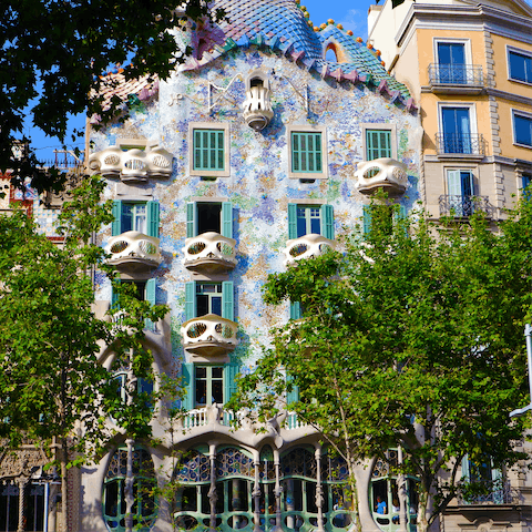 Admire the striking facade of Casa Batlló, about twenty minutes away by metro